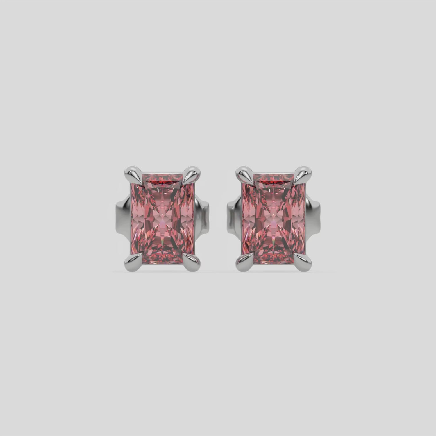 This video features a white gold Classic Radiant Diamond Earrings made with a fancy pink radiant-cut diamonds set in a four prong setting