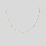 This yellow gold Round Dangling Diamond Necklace made with five round brilliant-cut diamond set in a prong setting, distributed evenly along the chain