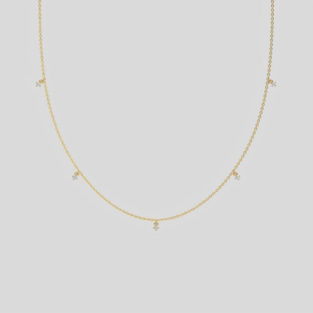 This yellow gold Round Dangling Diamond Necklace made with five round brilliant-cut diamond set in a prong setting, distributed evenly along the chain