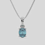 This white gold Fancy Blue Oval Solitaire Diamond Necklace made with an fancy Blue oval cut diamond in a four prong setting with adjustable chain 