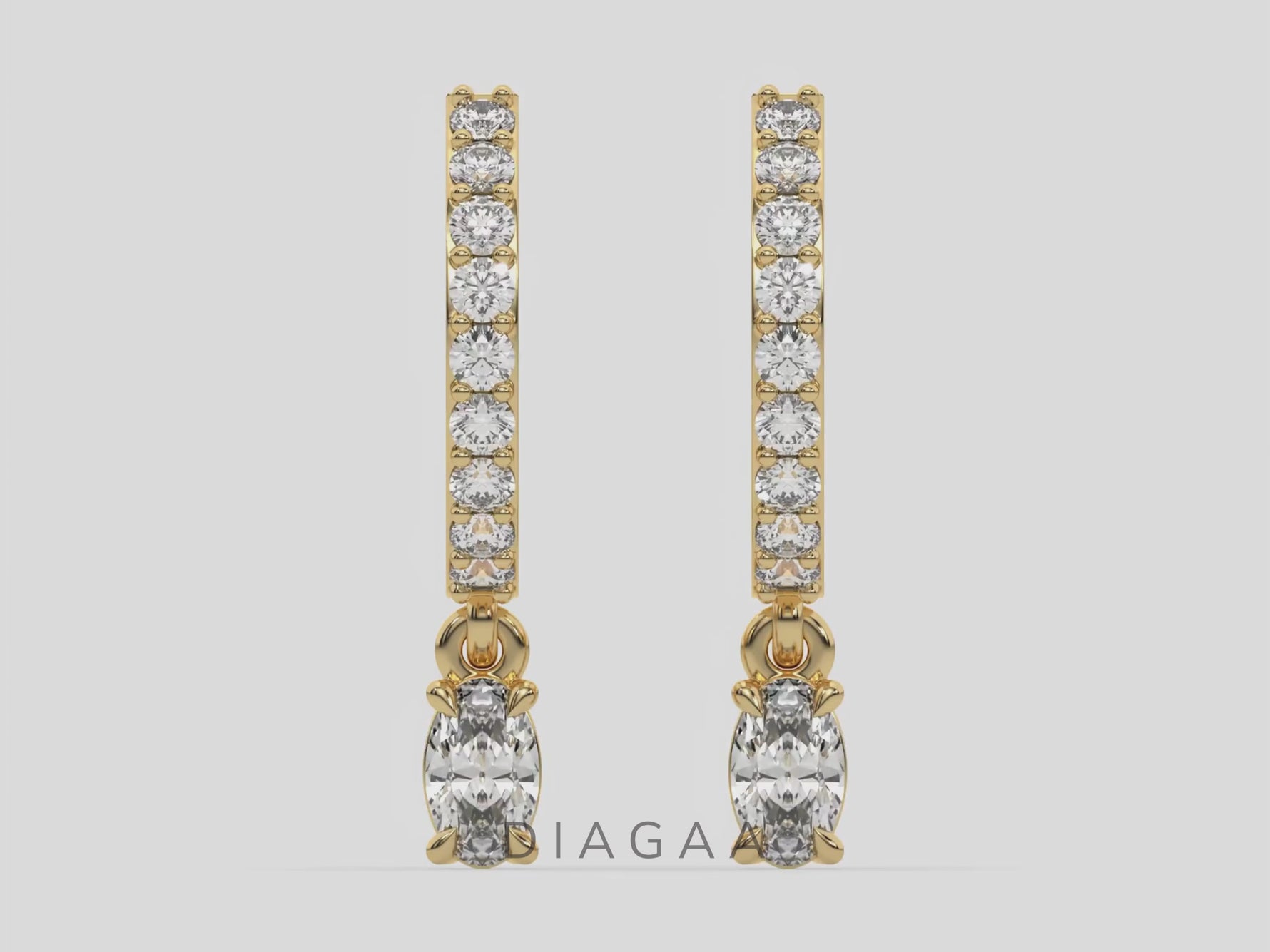 18k Yellow gold dangling oval diamond hoop earrings with round brilliant cut diamonds in prong setting in hoop.