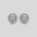 This video features a white gold Classic Oval Diamond Halo Earrings made with an oval-cut solitaire diamonds set in a four prong setting