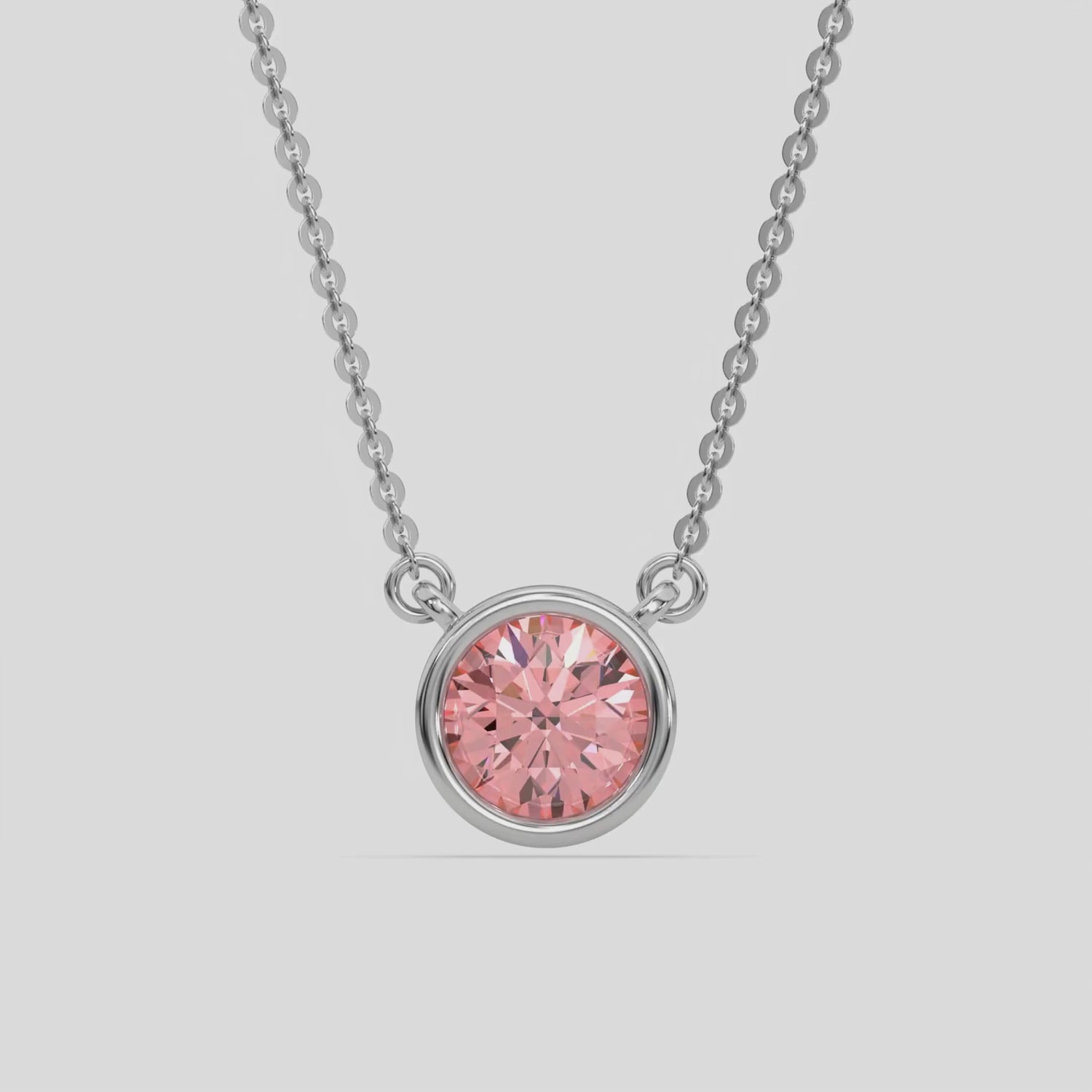 This white gold Fancy Pink Round Solitaire Diamond Necklace made with a fancy Pink round brilliant-cut diamond in bezel setting with adjustable chain 