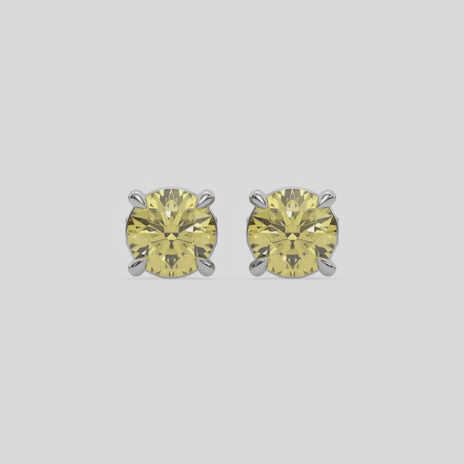 This video features a white gold Classic Round Diamond Studs made with fancy yellow round brilliant-cut diamonds set in a four prong setting