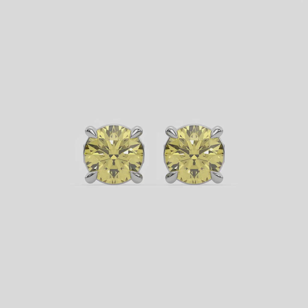 This video features a white gold Classic Round Diamond Studs made with fancy yellow round brilliant-cut diamonds set in a four prong setting