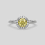 This video features a white gold ring features a fancy Yellow round solitaire diamond set in a four-prong setting