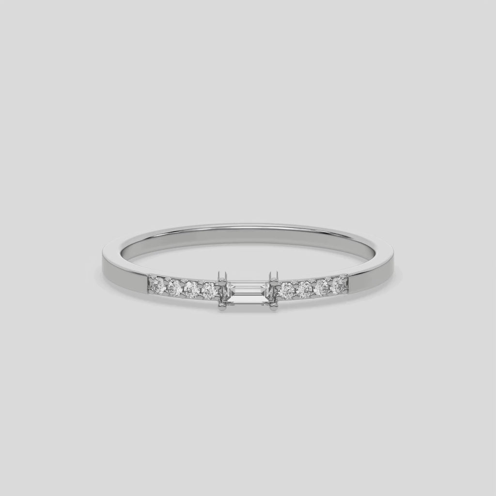 This video features a white gold Petite Baguette Diamond Ring handcrafted with a baguette diamond in the center and flanked by three round brilliant-cut diamonds on each side. The baguette diamond is set in a four prong setting