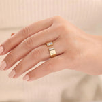 Woman wearing a 14K yellow gold princess diamond open cuff wedding band