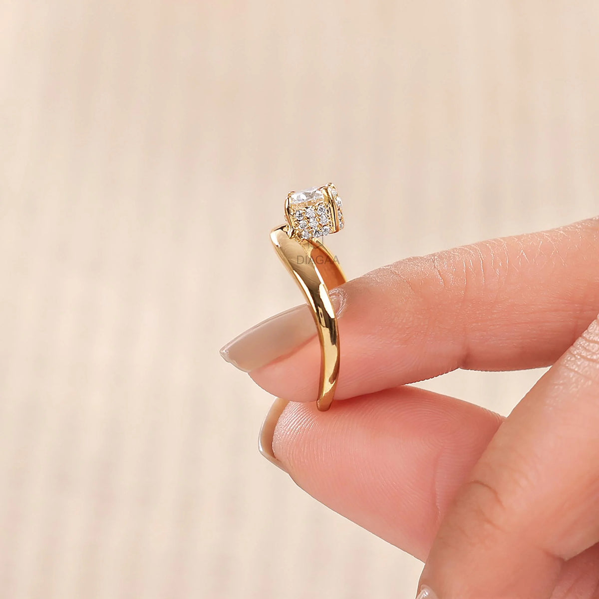 18K yellow gold round diamond solitaire engagement ring with a hidden halo curved band on a woman's hand